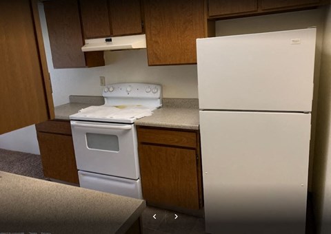 a kitchen with a stove and a refrigerator
